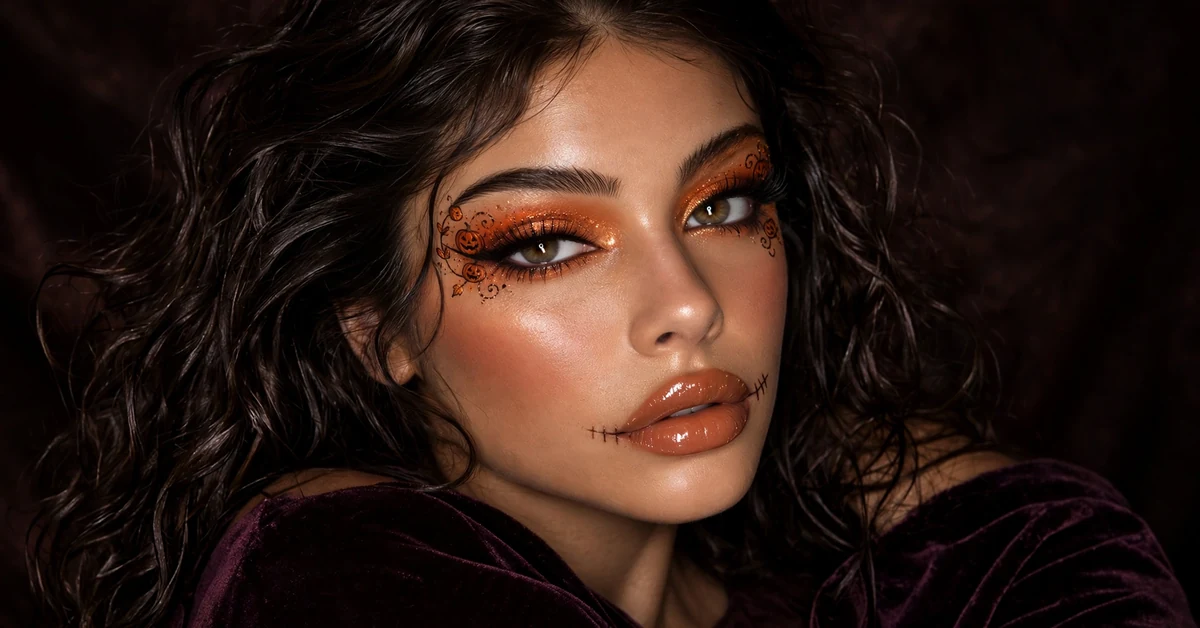 Glam pumpkin patch Halloween eye art and stitched lips makeup look